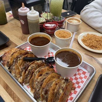 Birrieria sinaloa - Quesabirria tacos with consume pair with beans and rice. Drinks were agua de horchata & pepino. - Tacos Near Me - Palm Desert, California Birrieria sinaloa - Quesabirria tacos with consume pair with beans and rice. Drinks were agua de horchata & pepino. - Tacos Near Me - Palm Desert, California