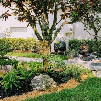 Green Team Solutions - a garden with a fountain - Landscaping Near Me - Wellington, Florida