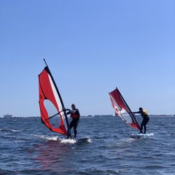 Outdoor Gulf Coast - Father and daughter doing great during their windsurfing lesson.