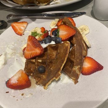 Tally's Silver Spoon - Oatmeal whole wheat waffles with vanilla yogurt basil and fruit. A star item! Half eaten by the time this photo was taken! - Desserts Near Me - Rapid City, South Dakota Tally's Silver Spoon - Oatmeal whole wheat waffles with vanilla yogurt basil and fruit. A star item! Half eaten by the time this photo was taken! - Desserts Near Me - Rapid City, South Dakota