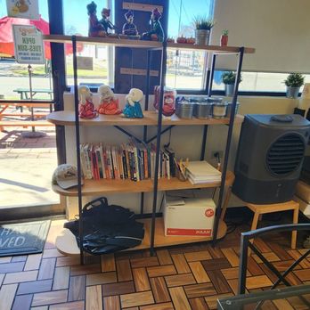 7 Monk's Cafe - Shelf at front with Ceramic Monks and some books - Indian Near Me - New Braunfels, Texas