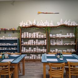 Ceramic Cafe - Craft tables and one of the racks filled with pieces you can buy to paint.