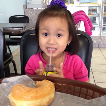 Snowflake Donuts - a little girl drinking a drink - Donuts Near Me - Houston, Texas