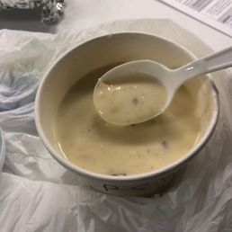 a bowl of soup with a spoon in it a bowl of soup with a spoon in it
