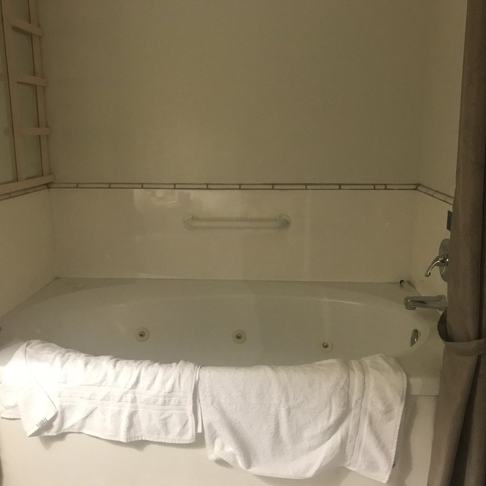 Forest Villas Hotel - I'm so sorry that I didn't snap a pic without the towels...trust me, this picture doesn't do the tub justice...it's huge! - Hotels Near Me - Prescott, Arizona