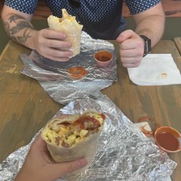 a man eating a burrito at a restaurant a man eating a burrito at a restaurant