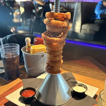 Ford's Garage Florence - GIANT FUNNEL TOWER OF JUMBO PISTON ONION RINGS Served with Homemade Chipotle Ketchup and Hidden Valley Ranch® - Burgers Near Me - Florence, Kentucky Ford's Garage Florence - GIANT FUNNEL TOWER OF JUMBO PISTON ONION RINGS Served with Homemade Chipotle Ketchup and Hidden Valley Ranch® - Burgers Near Me - Florence, Kentucky