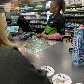 7-Eleven - a woman at a cash register in a grocery store - Convenience Stores Near Me - San Jose, California