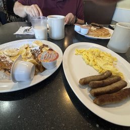 Sausage links, eggs, French toast with bananas. Sausage links, eggs, French toast with bananas.