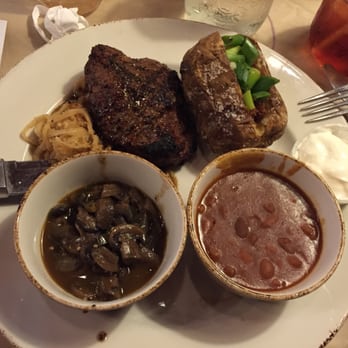Montana's - Tiny 8oz steak with an mini baked potato - the smallest I've ever seen. And soupy baked beans & unappetizing sauteed onion sauce. - Steakhouses Near Me - Burlington, Ontario