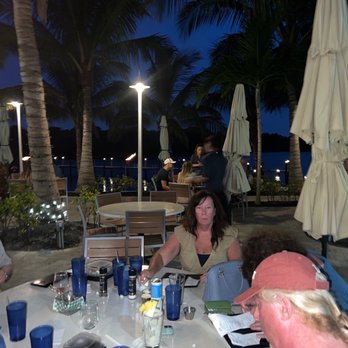 Frigate's Waterfront Bar and Grill - Diners sitting outside on the lower terrace on the riverside. - Seafood Near Me - Melbourne, Florida