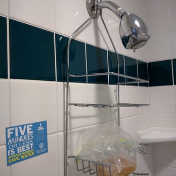 San Anselmo Inn - Drippy showerhead next to drought conscious sticker. - Hotels Near Me - San Anselmo, California