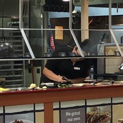 Golden Corral Buffet & Grill - Cashier, checking food temps. No gloves, leaning over the food, no hairnet!!