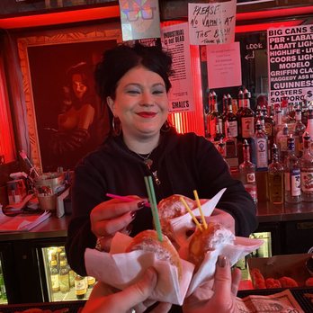 Small's Bar - a woman handing a hot dog to a man - Music Venues Near Me - Hamtramck, Michigan Small's Bar - a woman handing a hot dog to a man - Music Venues Near Me - Hamtramck, Michigan