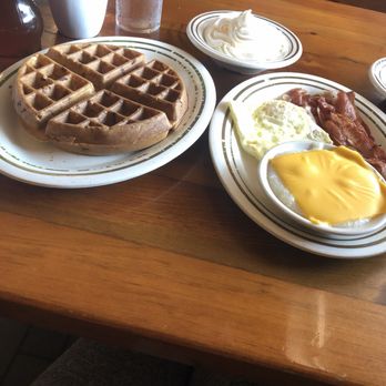 Famous Amos - Crispy waffle, side of whipped cream, limp bacon, over medium eggs & cheese grits - Southern Near Me - Jacksonville, Florida