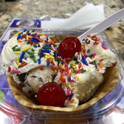 Lucky 7’s Deli On 5th - Waffle cone with vanilla and cookies and cream ice cream, rainbow sprinkles and maraschino cherries.
