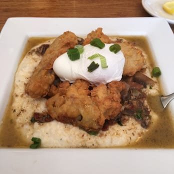 Spoons Cafe - Amazing dish... Grits, fried oysters, poached egg with sautéed mushrooms and some sauce (idk what the sauce is) but still amazing! - New American Near Me - Baltimore, Maryland