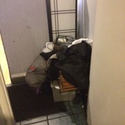 Photo of Zara Afghan Cuisine - Sacramento, CA, United States. Bags full of dirty towels in front of the bathroom entryway
