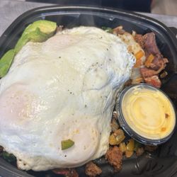 The Breakfast Nook - Chorizo and bacon with hash brown, peppers and onion, eggs, avocado, hollandaise sauce.