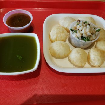 Neehee's Hanover Park, Illinois - Pani Puri - Indian street food platter featuring Pani Puri with tamarind and green chutney, served with a side of spicy flavored water. - Indian Near Me - Hanover Park, Illinois