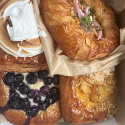 Top: Left: lemon-raspberry meringue danish Right: elote danish Bottom left: blueberry danish Right: pineapple/passionfruit coconut danish Top: Left: lemon-raspberry meringue danish Right: elote danish Bottom left: blueberry danish Right: pineapple/passionfruit coconut danish