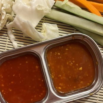 Tiger Mama - Appetizer - Vegetables including cabbage, cucumber, carrots, and zucchini are arranged on a tray with two types of dipping sauce in a metal container. - Korean Near Me - Eugene, Oregon