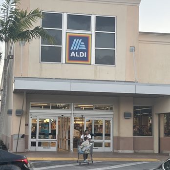 ALDI - a woman pushing a shopping cart in front of a aldi store - Grocery Near Me - Pembroke Pines, Florida ALDI - a woman pushing a shopping cart in front of a aldi store - Grocery Near Me - Pembroke Pines, Florida