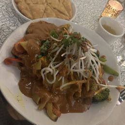 Peanut sauce with noodles with fried tofu. Roti to the side. Also green tea! Peanut sauce with noodles with fried tofu. Roti to the side. Also green tea!