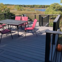 The Deck Builder of Colorado - Two-level composite deck with iron railing and composite drink rail to maximize view of lake.