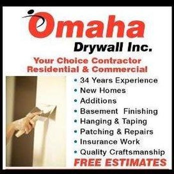 Omaha Drywall - a hand holding a paintbrush - General Contractors Near Me