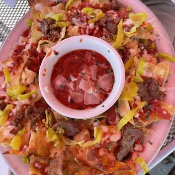 Old Chicago Pizza + Taproom - a plate of nachos with a bowl of salsa - Pizza Near Me - Sioux City, Iowa Old Chicago Pizza + Taproom - a plate of nachos with a bowl of salsa - Pizza Near Me - Sioux City, Iowa