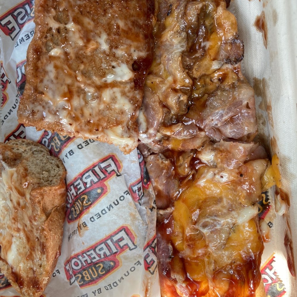 Firehouse Subs - a close up of a piece of pizza - Sandwiches Near Me - Nashville, Tennessee