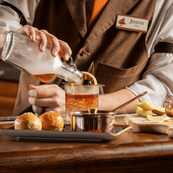 Harry's Cocktail Lounge & Bar - A bartender pours the Harry's Old Fashioned
