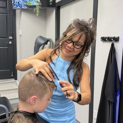 Lilly's Beauty Salon - Lilly cutting hair.