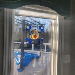 Artists In Paradise Gallery - Stained glass with shell. Looks see through with sunshine.