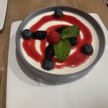 The Kitchen Table - Buttermilk panna cotta with raspberry coulis and fresh berries - Italian Near Me - Reno, Nevada