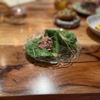 Barley Swine - a plate of food on a wooden table - New American Near Me - Austin, Texas Barley Swine - a plate of food on a wooden table - New American Near Me - Austin, Texas
