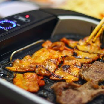 H Mart - Cambridge - a close up of a grill with meat being cooked - Grocery Near Me - Cambridge, Massachusetts H Mart - Cambridge - a close up of a grill with meat being cooked - Grocery Near Me - Cambridge, Massachusetts