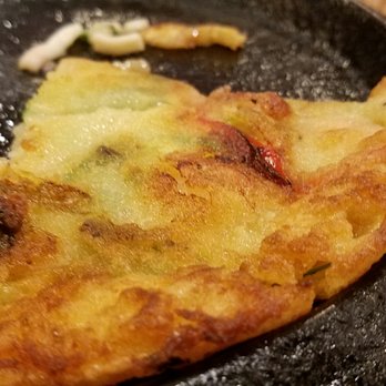 Lighthouse Tofu - What is left of our seafood pancake. Crisp and oh so good! - Korean Near Me - Annandale, Virginia