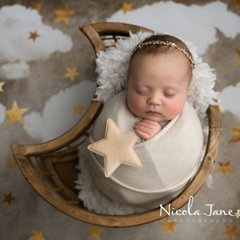 Nicola Jane Photography - A photo of a newborn baby posed in a moon basket. - Session Photography Near Me Nicola Jane Photography - A photo of a newborn baby posed in a moon basket. - Session Photography Near Me