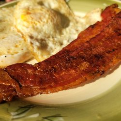 All In Flavor Cafe and Sweets - Over easy eggs with crispy bacon