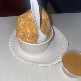 Yogurt & Such - a person scooping into a bowl of yogurt - Ice Cream & Frozen Yogurt Near Me - Greenvale, New York