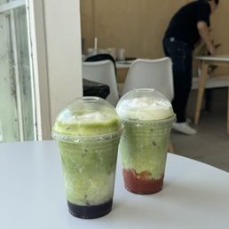 Wild Blueberry Iced Matcha Latte & Strawberry Iced Matcha Latte with cream on top