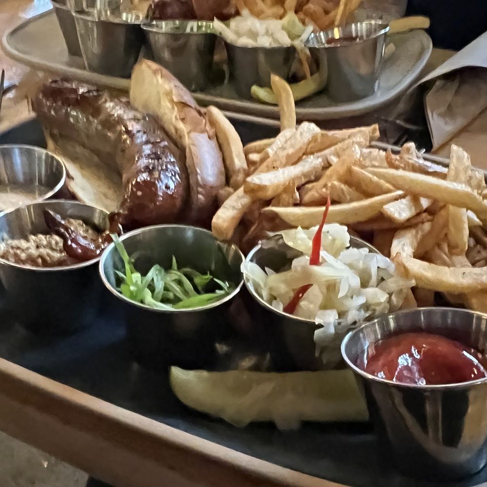 Steam Whistle Kitchen - Bratwurst, with toppings on the side - Salad Near Me - Toronto, Ontario Steam Whistle Kitchen - Bratwurst, with toppings on the side - Salad Near Me - Toronto, Ontario