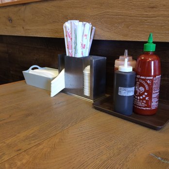 AJ Noodles - Table setting. Sriracha, looks like sambal, and a mysterious dark paste hahaha. - Vietnamese Near Me - Glendale, California AJ Noodles - Table setting. Sriracha, looks like sambal, and a mysterious dark paste hahaha. - Vietnamese Near Me - Glendale, California