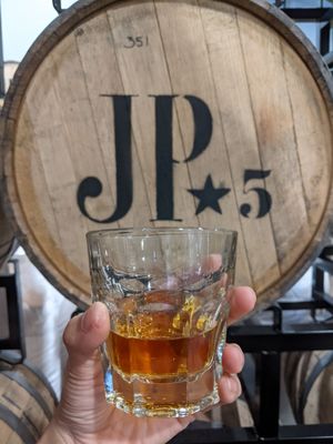 Photo of JP Trodden Distilling - Maltby, WA, US. a person holding a glass of whiskey