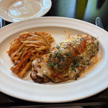 Il Piatto - eggplant parmesan - A dish of eggplant parmesan with melted cheese and herbs, served with a side of pasta in tomato sauce, on a white plate. - Italian Near Me - Washington, DC, District of Columbia