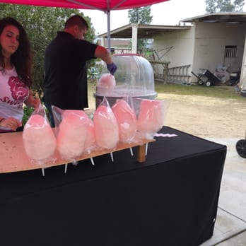 Sweetie's Candy - a man and a woman standing under a pink tent - Food Trucks Near Me - Clovis, California Sweetie's Candy - a man and a woman standing under a pink tent - Food Trucks Near Me - Clovis, California