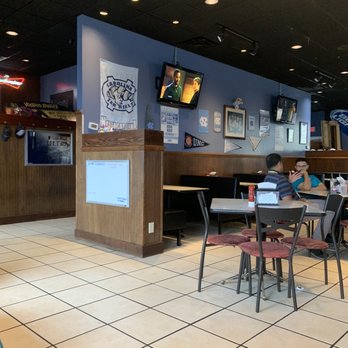 Karondas - a woman sitting at a table in a restaurant - Sports Bars Near Me - Greensboro, North Carolina Karondas - a woman sitting at a table in a restaurant - Sports Bars Near Me - Greensboro, North Carolina