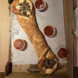 Rosario's Trattoria - Stuffed roll with sausage, peppers, onions, and mozzarella cheese. Four small containers with marinara sauce.
